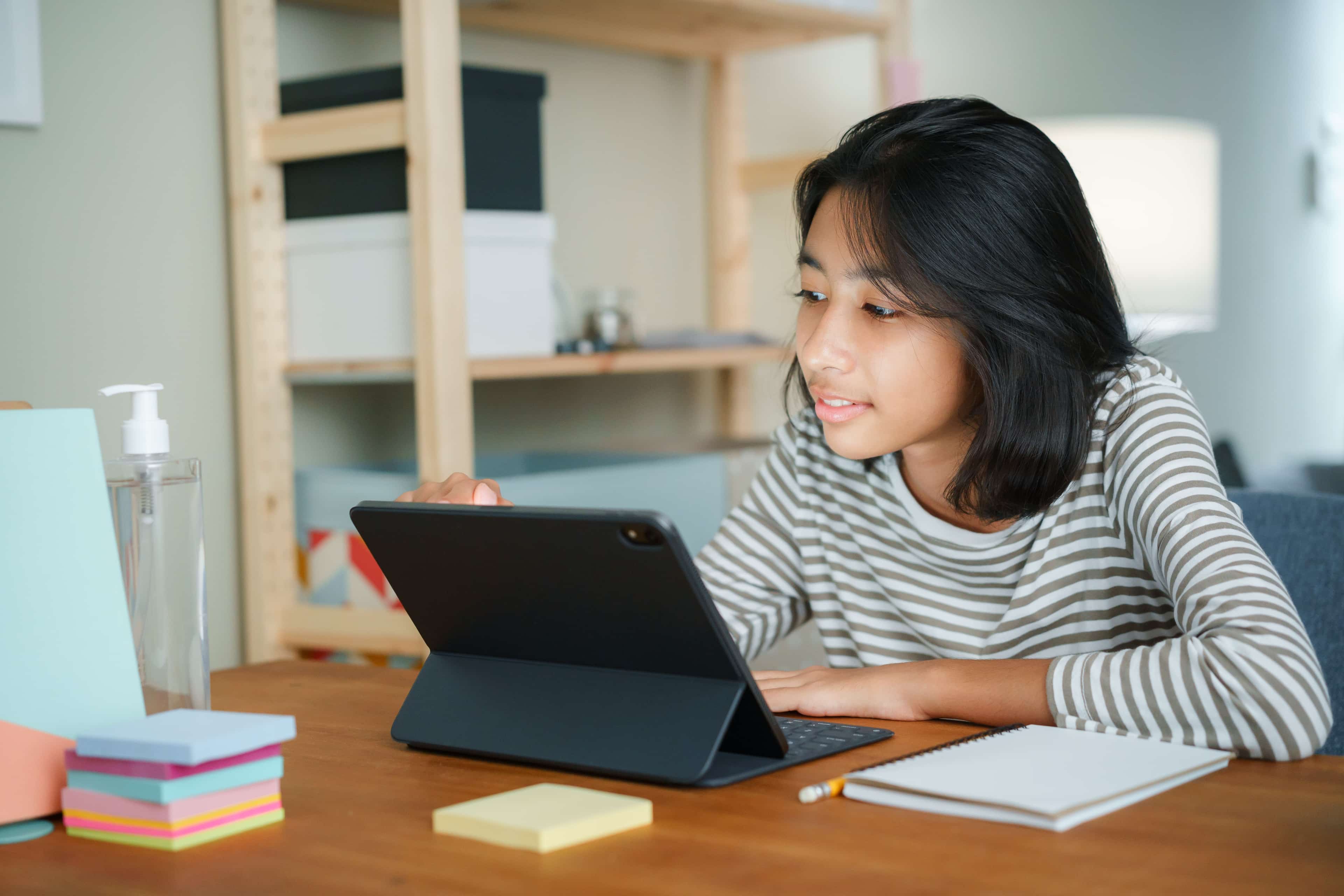 High school student taking a Wake Forest business course on a tablet